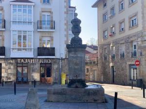 a statue in a courtyard in front of a building at Apartament 3 Bedrooms 80m2 con WIFI Alto Campoo Reinosa Cantabria in Reinosa