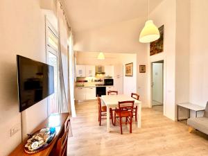 a kitchen and dining room with a table and chairs at Villa Poetto Beach by Home and Experience , Cagliari, Poetto in Cagliari