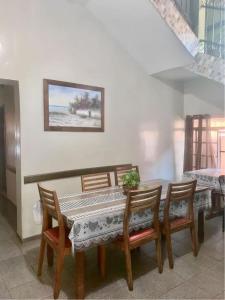 a dining room table and chairs with a picture on the wall at Hotel Económico in Campo Grande