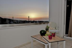 a living room with a table and a view of a city at Serenity Retreat , By IdealStay Experience in Gournes