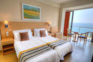 Кровать или кровати в номере The Preluna Hotel