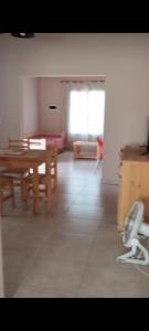 a living room with a table and a chair at Cabaña Dina in Santa Rosa del Conlara +1 photo