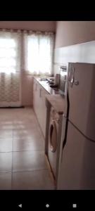 a kitchen with a refrigerator and a dishwasher at Cabaña Dina in Santa Rosa del Conlara +1 photo