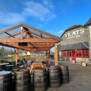 a group of barrels sitting in front of a building at The Yeats County Inn Hotel in Tobercurry