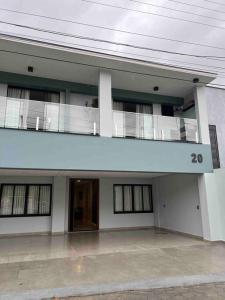 a large building with a balcony on top of it at Caminho do Mar Ap 4 in Governador Celso Ramos