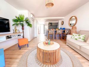 a living room with a couch and a table at Ultramarine direct access to Orient Bay beach 2 bedrooms in Orient Bay +15 photos