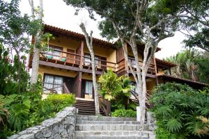 a house in the middle of a garden at Hotel La Forêt & Beach Lounge in Búzios