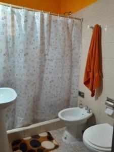 łazienka z toaletą i zasłoną prysznicową w obiekcie Malvinas casa w mieście La Plata