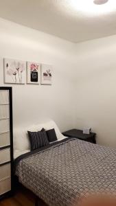 a bedroom with a bed and a wall with pictures at Pinkston Gardens in Saint Paul