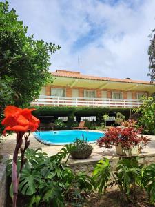 a resort with a swimming pool and a building at Velho Estaleiro Apartamentos por Temporada in São Lourenço do Sul