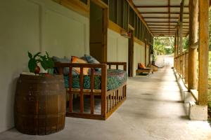 a bedroom with a bed in a building with a barrel at Casa Raiz in Puerto Viejo