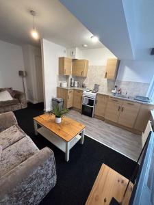 a living room with a couch and a table at Two bedroom apartment room 18 in Stockton-on-Tees