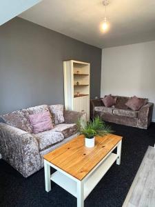 a living room with a couch and a coffee table at Two bedroom apartment room 18 in Stockton-on-Tees