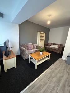 a living room with a couch and a coffee table at Two bedroom apartment room 18 in Stockton-on-Tees