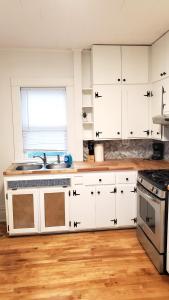 a kitchen with white cabinets and a sink at Pinkston Gardens in Saint Paul