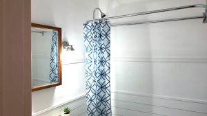 a bathroom with a shower curtain and a mirror at Pinkston Gardens in Saint Paul +50 photos