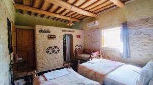 Postel nebo postele na pokoji v ubytování Kasbah Dar Talouste