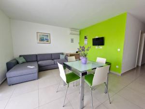 a living room with a table and a couch at Vila Novak in Novalja