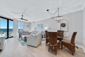 a living room with a table and chairs and a dining room at Phoenix East II 2044 in Orange Beach