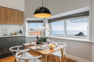 a kitchen and dining room with a table and chairs at Tower House Apartments in Bournemouth