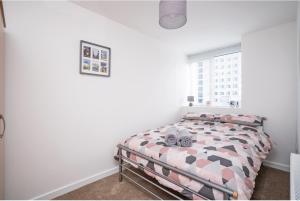 a bedroom with a bed with two clocks on it at MayDisc Long Stay Contractors in Portsmouth