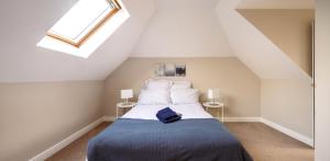 a bedroom with a bed with a blue blanket at Family home in central Guildford with Parking in Guildford