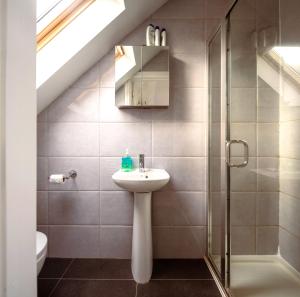 a bathroom with a sink and a shower at Family home in central Guildford with Parking in Guildford