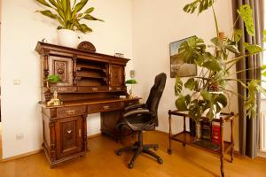 an office with a desk and a chair and plants at Villa Haag in Haag