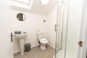 a white bathroom with a toilet and a sink at Suite 6 - Double Room in the Heart of Oldham in Oldham