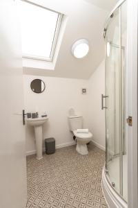 a bathroom with a toilet and a sink and a shower at Suite 6 - Double Room in the Heart of Oldham in Oldham