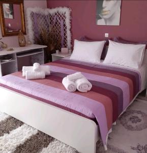 a bedroom with a large bed with towels on it at DreamHouse in Nafpaktos