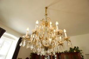 a chandelier hanging from a ceiling in a room at Villa Haag in Haag