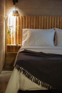 a bedroom with a large bed with a wooden headboard at Hotel Cytrico in Medellín