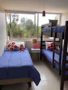 a bedroom with two bunk beds and a window at Bello departamento Algarrobo in Algarrobo
