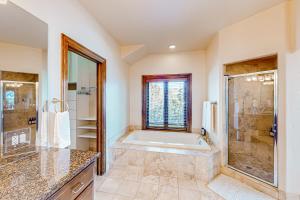 a large bathroom with a tub and a shower at Mountain Range Manor in Eagle