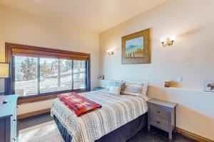 a small bedroom with a bed and a window at Mountain Range Manor in Eagle