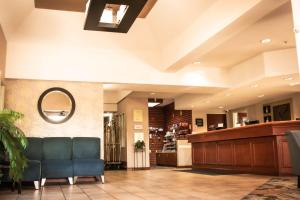 a lobby with a waiting room with a blue couch at Comfort Suites Airport in Salt Lake City