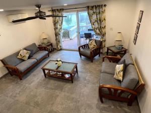 a living room with couches and chairs and a table at 4 Guests - Stunning View - Pool - South Finger in Jolly Harbour