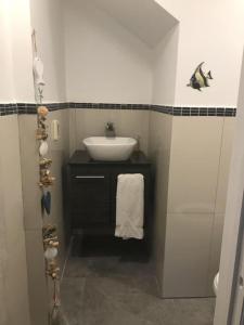 a small bathroom with a sink and a white sink at 4 Guests - Stunning View - Pool - South Finger in Jolly Harbour