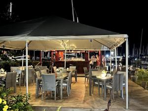 a restaurant with tables and chairs under a tent at 4 Guests - Stunning View - Pool - South Finger in Jolly Harbour