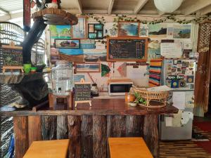 a restaurant with a counter with a chalk board at ThaiMex Cafe & Homestay Backpackers- Adults Only in Prachuap Khiri Khan +37 photos