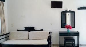 a living room with a couch and a mirror at Lodge Narlis in Platis Gialos