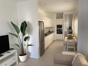a kitchen with white cabinets and a potted plant at Casa Ma in Guatiza