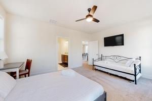 a bedroom with two beds and a ceiling fan at The Waterside Gaming Retreat in Seaford