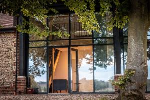 a glass house with a chair in front of it at Beaumont Mews in Saint Albans