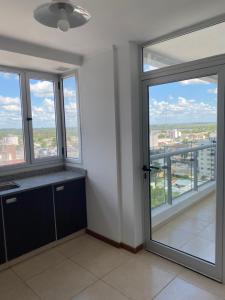 a kitchen with windows and a view of a city at Moderno departamento en el centro in Concordia