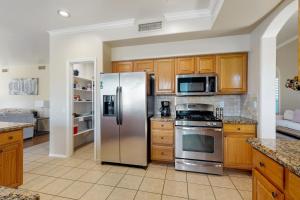 a kitchen with stainless steel appliances and wooden cabinets at Mesa Resort in Leisure World