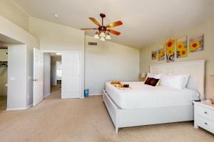 a bedroom with a white bed and a ceiling fan at Mesa Resort in Leisure World +20 photos