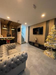 a living room with a couch and a christmas tree at HOTEL SALVATORE in Paipa