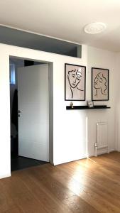 a room with a door and two pictures on the wall at Helle Wohnung in Top Lage! in Linz